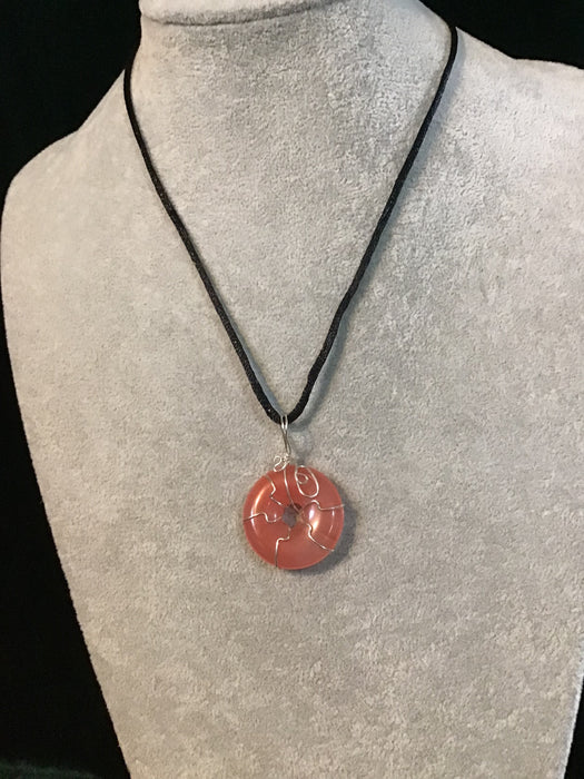 Wire wrapped gemstone donut on18" black satin adjustable cord.