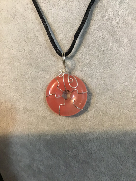 Wire wrapped gemstone donut on18" black satin adjustable cord.