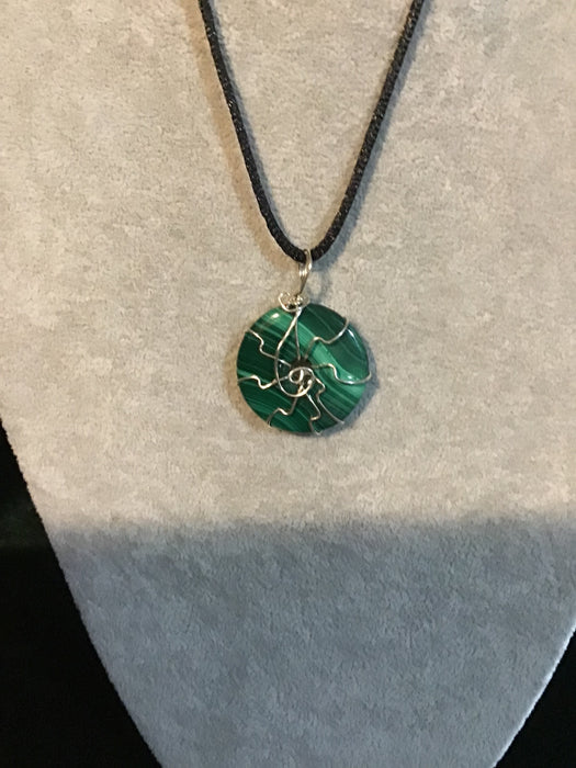 Wire wrapped gemstone donut on18" black satin adjustable cord.
