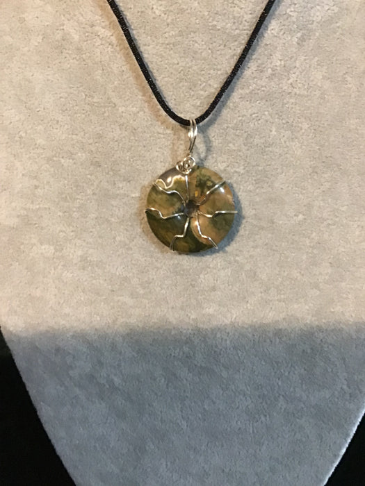 Wire wrapped gemstone donut on18" black satin adjustable cord.