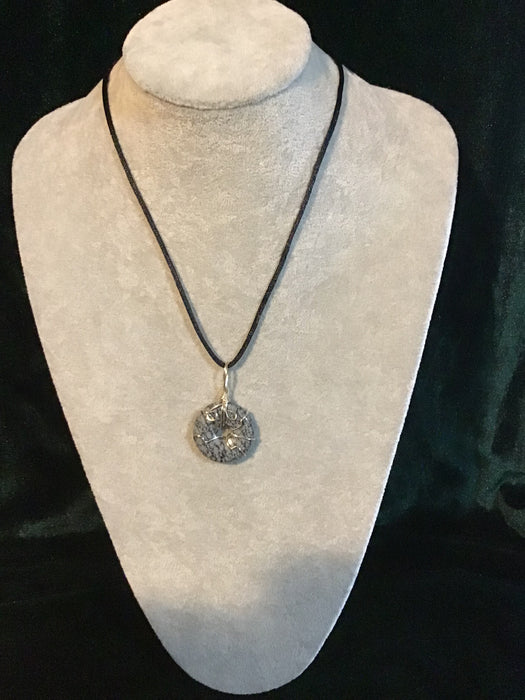 Wire wrapped gemstone donut on18" black satin adjustable cord.