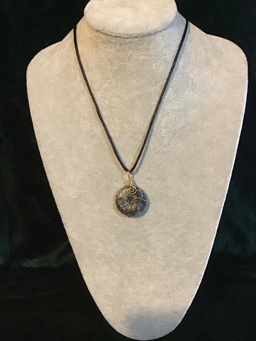Wire wrapped gemstone donut on18" black satin adjustable cord.