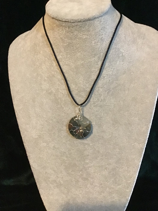 Wire wrapped gemstone donut on18" black satin adjustable cord.