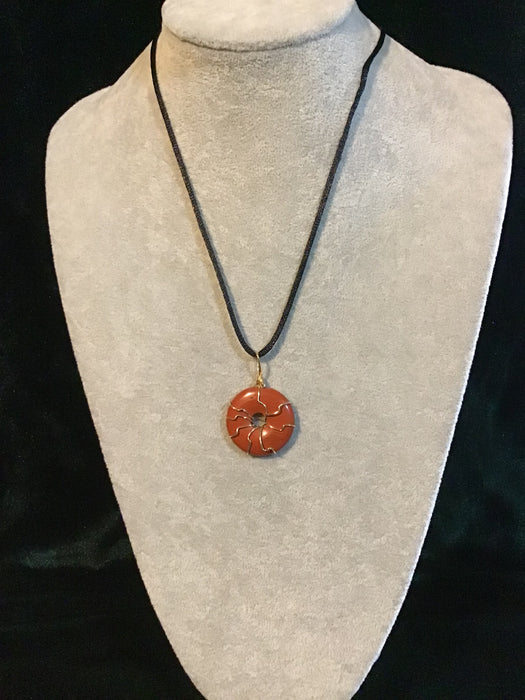 Wire wrapped gemstone donut on18" black satin adjustable cord.