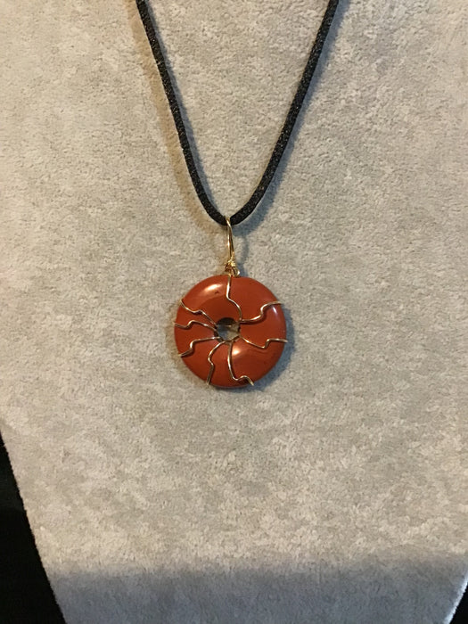 Wire wrapped gemstone donut on18" black satin adjustable cord.