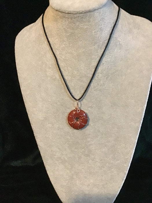 Wire wrapped gemstone donut on18" black satin adjustable cord.