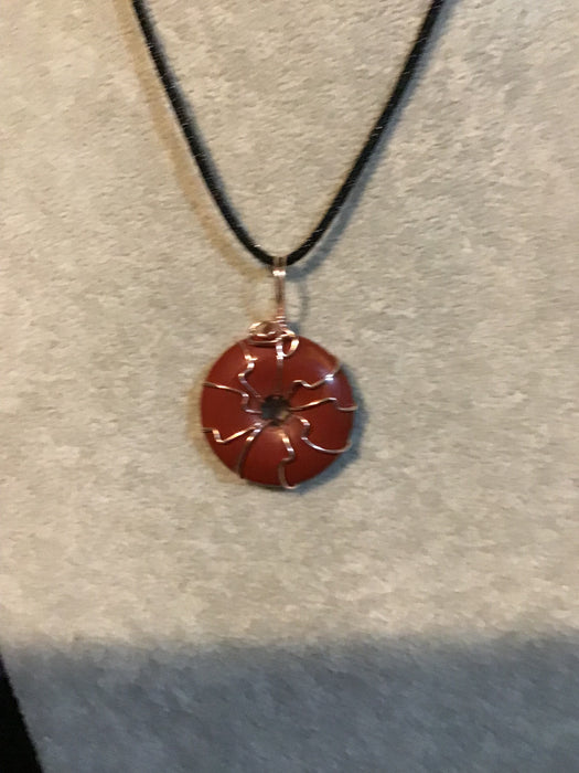 Wire wrapped gemstone donut on18" black satin adjustable cord.