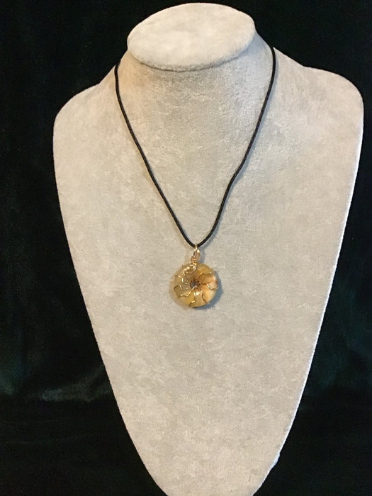 Wire wrapped gemstone donut on18" black satin adjustable cord.