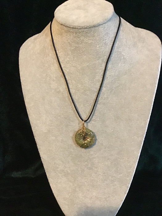 Wire wrapped gemstone donut on18" black satin adjustable cord.