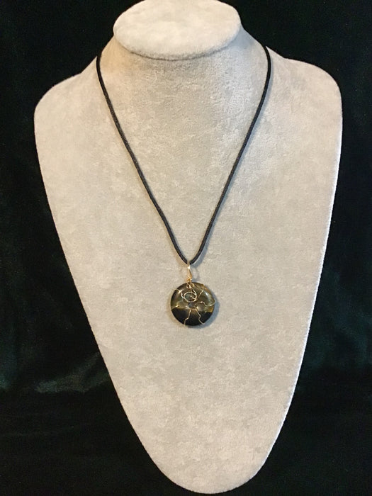 Wire wrapped gemstone donut on18" black satin adjustable cord.