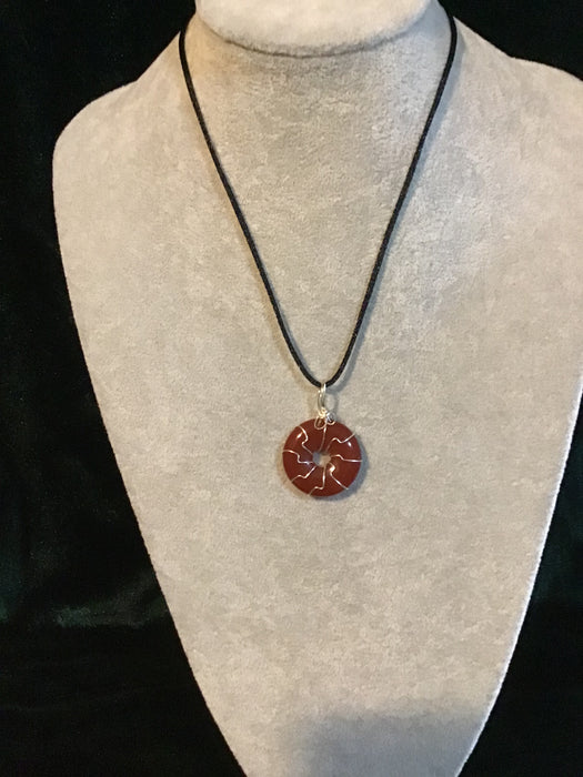 Wire wrapped gemstone donut on18" black satin adjustable cord.