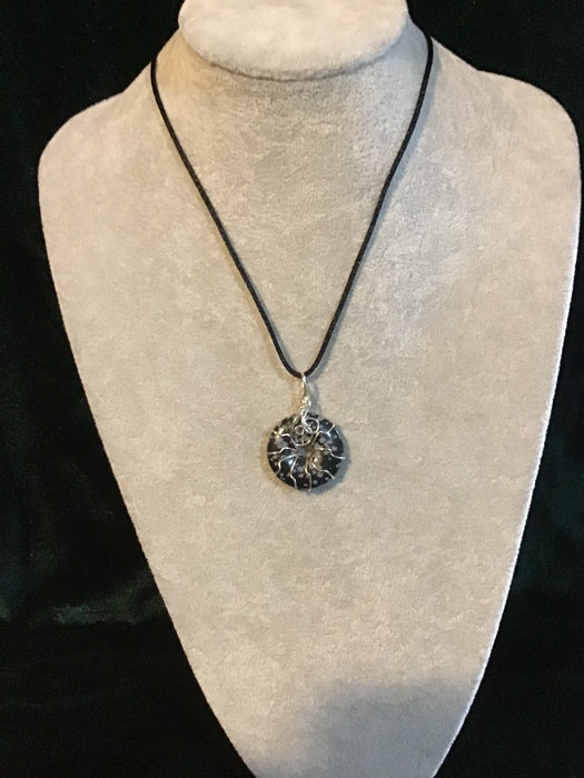 Wire wrapped gemstone donut on18" black satin adjustable cord.