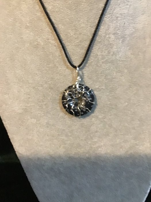 Wire wrapped gemstone donut on18" black satin adjustable cord.