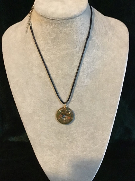 Wire wrapped gemstone donut on18" black satin adjustable cord.