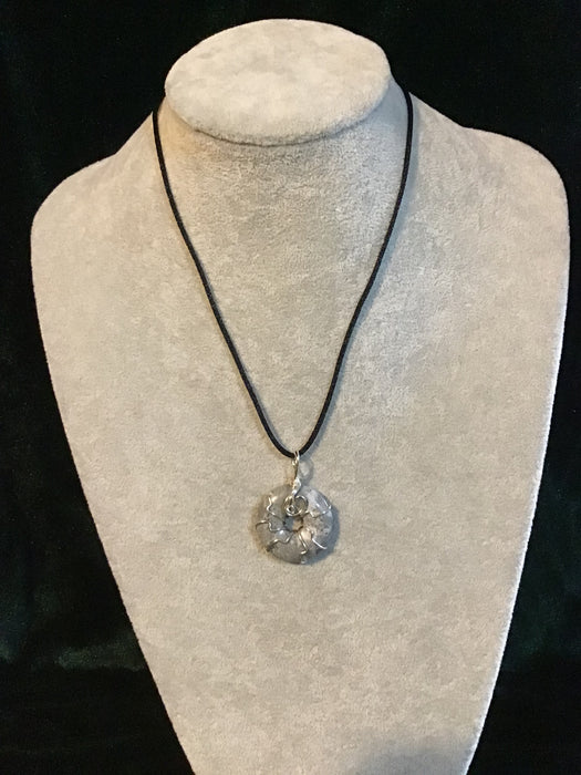 Wire wrapped gemstone donut on18" black satin adjustable cord.