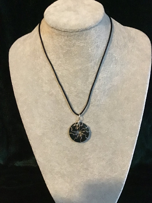 Wire wrapped gemstone donut on18" black satin adjustable cord.