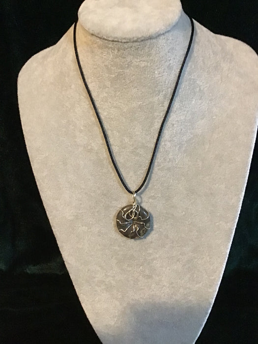 Wire wrapped gemstone donut on18" black satin adjustable cord.