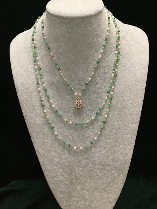Multi-strand necklace with snowflake centerpiece.
