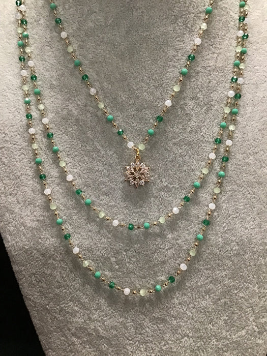 Multi-strand necklace with snowflake centerpiece.