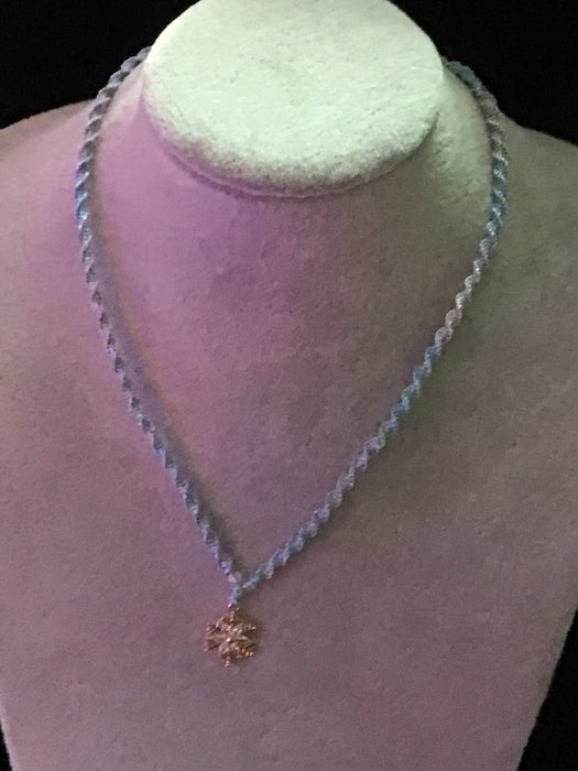 Macrame necklace with snowflake pendant.