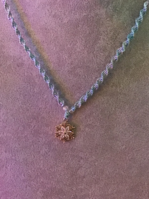 Macrame necklace with snowflake pendant.