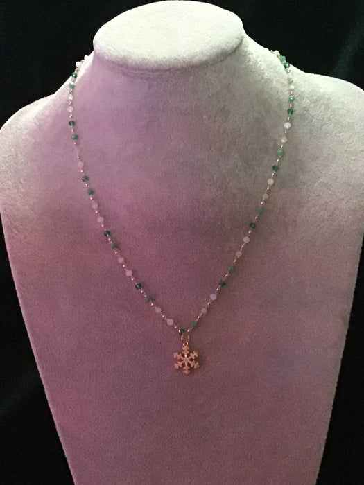 Single strand crystal chain necklace with snowflake pendant.