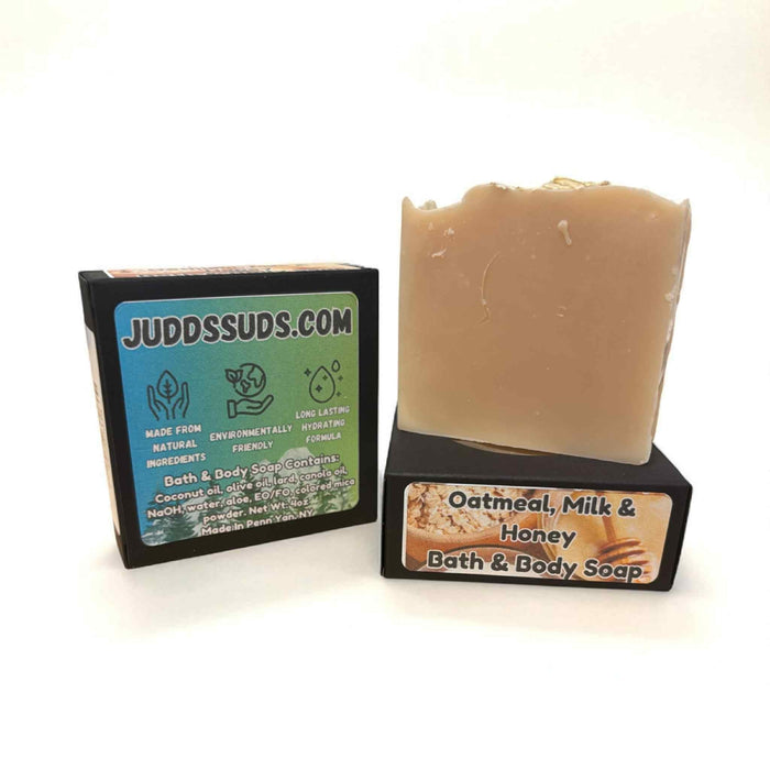 Bar of oatmeal, milk, and honey bath and body soap with packaging on a white background